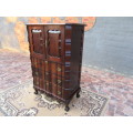 A beautiful Stinkwood ball and claw `Tallboy` multi-purpose cabinet with 3 drawers