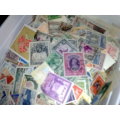 JUST RECEIVED=ICE CREAM TUB ALMOST FILLED WITH THOUSANDS OF STAMPS-INTERESTING!!