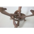 Interlocking carved stand with giraffe heads, supporting wooden bowl - 20cm tall