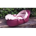 Old maroon baby carry cot.