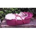 Old maroon baby carry cot.