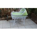 Lovely white cane bassinet on a stand.