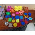 Collection of kids plastic dough cutters and moulds.