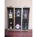 Old wooden drawer display rack of old bottles.
