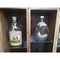 Old wooden drawer display rack of old bottles.