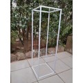 White metal and glass stand.