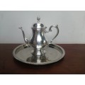 Beautiful vintage silver plated tea pot on a tray.