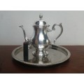 Beautiful vintage silver plated tea pot on a tray.