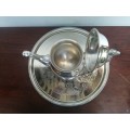Beautiful vintage silver plated tea pot on a tray.