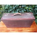 Large brown vintage suitcase.