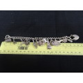 Stunning Sterling Silver Charm Bracelet With Heart Locker and Fourteen Silver Charms On (63 Gram)