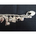 Stunning Sterling Silver Charm Bracelet With Heart Locker and Fourteen Silver Charms On (63 Gram)