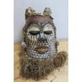 African wood and material carved tribal mask head