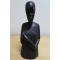 A pair of small African carved wooden figures