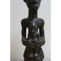 Central African carved wooden figure of a mother holding her baby