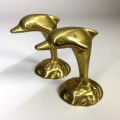 A  MATCHED PAIR  OF SOLID BRASS, DOLPHIN  ORNAMENTS