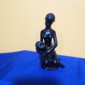 Vintage Black Resin semi nude African Woman seated Figurine with Water Jug. Excellent detail !