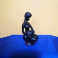 Vintage Black Resin semi nude African Woman seated Figurine with Water Jug. Excellent detail !