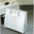 Crocodile pattern stereotyped fashion steel handle handbag. Grey color.