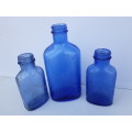 Light blue embossed MILK OF MAGNESIA vintage bottles