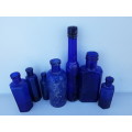 Seven antique and vintage blue bottles