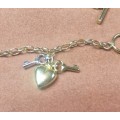 9 K / 9 carat solid Gold, Imported 3 mm. oval FOB Belcher bracelet with 3 charms