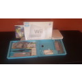 Nintendo Wii with two games, sensor bar, Wii controller and nunchuk and stand for Wii