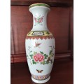 HANDPAINTED CHINESE PORCELAIN VASE, FILLED WITH CONTENTS STILL INSIDE.