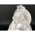 A SMALL LAUGHING BUDDHA FIGURINE CARVED IN CLEAR QUARTZ