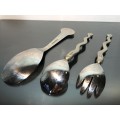 A set of Carol Boyes Wave Salad Spoons and a Larger Serving Spoon