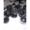 Rare Black Canon AE1 35mm SLR Film Camera Black camera with 4 lenses.
