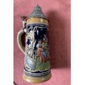 Vintage German ceramic beer mug with a hinged pewter lid.