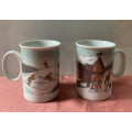 Porsgrund Norway Pair of ceramic mugs with a scene of elves skiing and ringing the house bell.