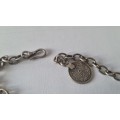 All metal necklace. Brass 9 discs and coin at clasp.