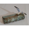 A ceramic water log with bird