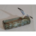 A ceramic water log with bird
