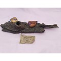 Two bird`s sitting on a log