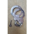 very good & well used old style used condition SAP (stamped) period hand-cuffs with key
