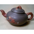 A Vintage Chinese Yixing Pottery Tea pot Signed under and flowers on the side with No damage.