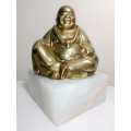 A laughing solid Brass Buddha on white Marble plinth. Symbol of prosperity in Feng Shui.