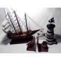 A Heavy Hand Made Sail boat plus Lighthouse 35cm tall and Anchor Bookends + a `WILLKOMMEN` sign.
