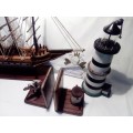 A Heavy Hand Made Sail boat plus Lighthouse 35cm tall and Anchor Bookends + a `WILLKOMMEN` sign.