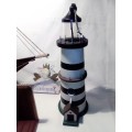 A Lighthouse which is a bird feeder. 35cm tall and + a `WILLKOMMEN` sign.
