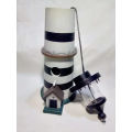 A Lighthouse which is a bird feeder. 35cm tall and + a `WILLKOMMEN` sign.