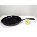 A vintage well seasoned cast iron Grid and handled Fry pan