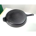 A vintage large pre seasoned with grid heavy cast iron cooking skillet pan with flu.