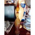 A rare old 58cm tall Amber studio glass Geni bottle in good used second hand condition.