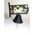 A Vintage Wall Hanging Cow bell motif with a clear ring. Size: 210mm Wide x 220mm High