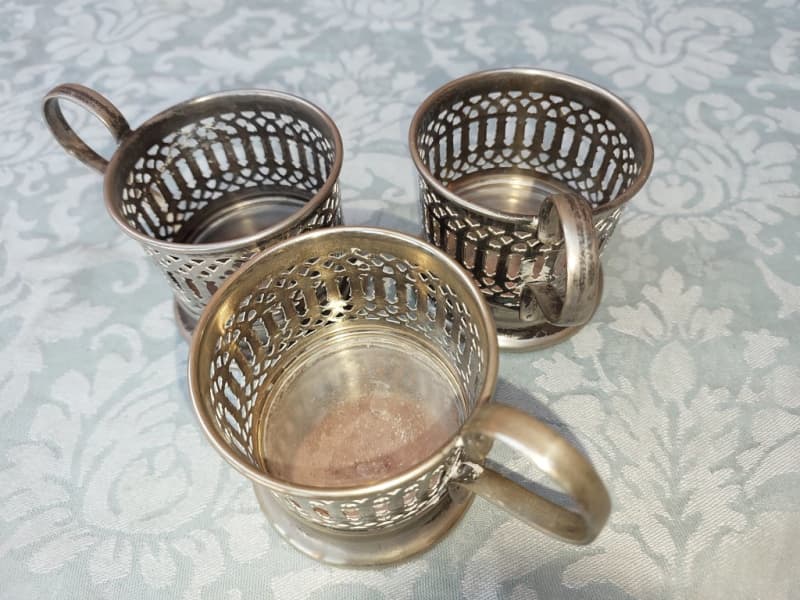A SET OF 3 HOT GLASS TEA OR COFFEE GLASS EPNS HOLDERS