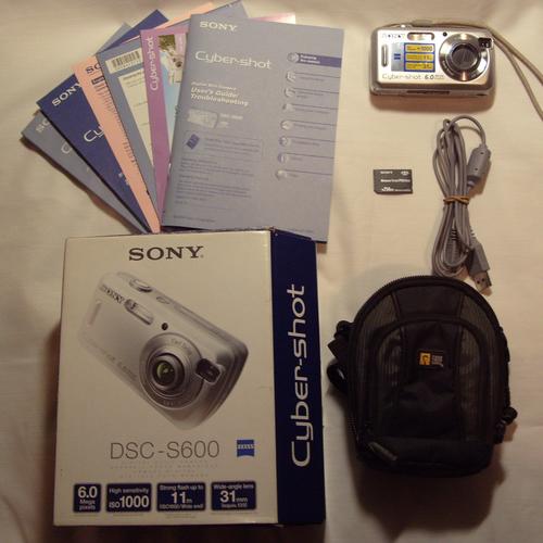 sony digital compact camera with memory card and bag
